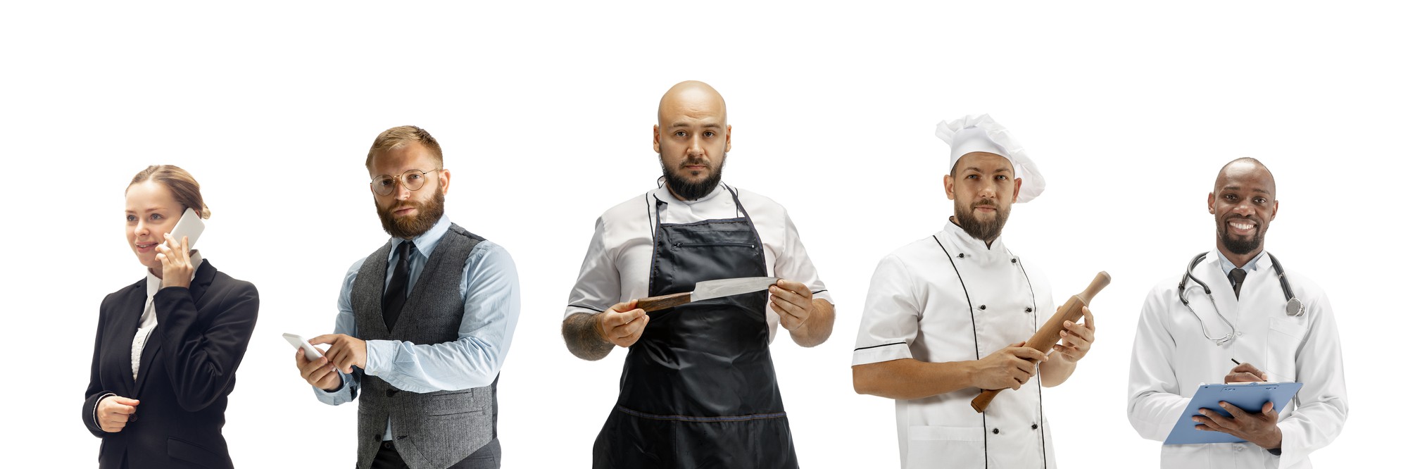 Chef consulting with team in small professional kitchen